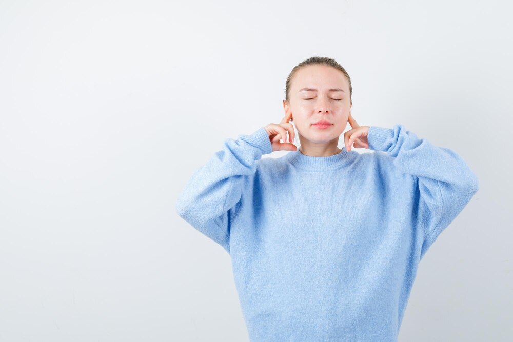 Blonde lady doesnt want to hear any sound on white background